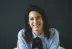 smiling woman in white and black checkered dress shirt