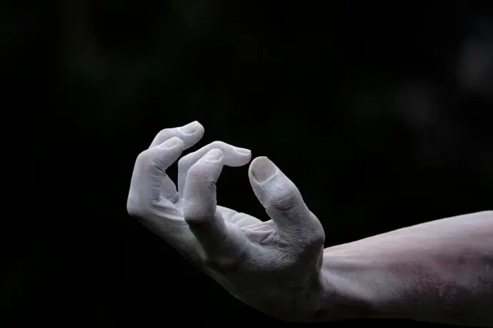 a person's hand with white paint on it